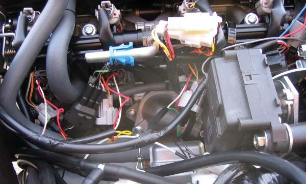 B 6 Unplug the stock wiring harness from each of the lower injectors as shown in Figure B.