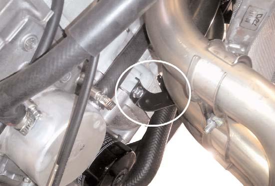 9) Remove the lower radiator mount bolt. (Fig. 4) Pulling the radiator away from the motor will allow more room to remove the stock exhaust system. 10)Remove all 8 headpipe flange mounting bolts.