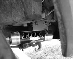 Fig. 2: Driver side Tighten all three bolts or nuts to 24 ft* lbs. 9. Connect the shock to the lower control arm with the longer spacer towards the rear of the vehicle, reusing the stock bolt and nut.