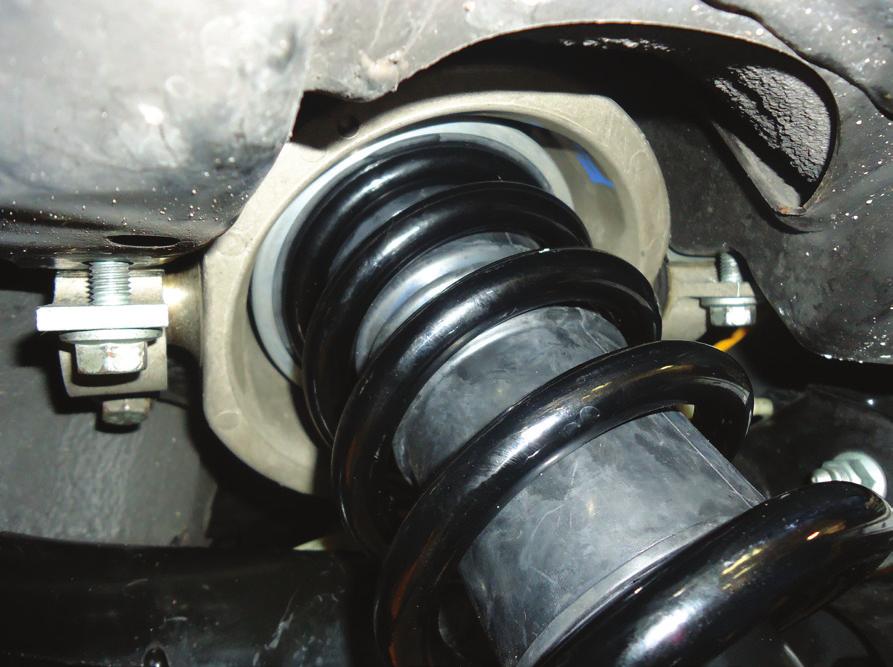 INSTALL THE COIL SPRING STRUT INTO THE REAR SUSPENSION CAVITY.