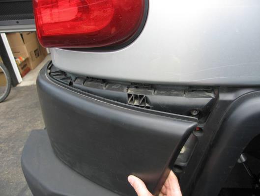 4.) Stand behind your vehicle and pull the bumper rearward while supporting the plastic bumper.