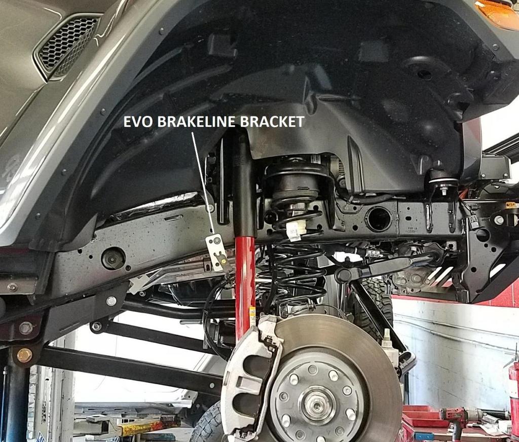 15. Install front EVO brake line extension bracket at original brake line mounting location on frame with factory bolt. 16.