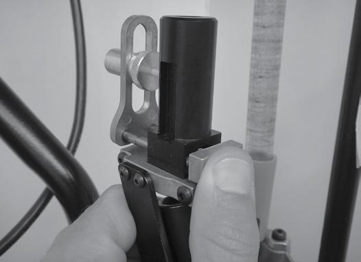 Manually squeeze the Bullet Feeder s Push Bar Mechanism, allowing the bullet to drop into the Seat Die Body (Photo 11).