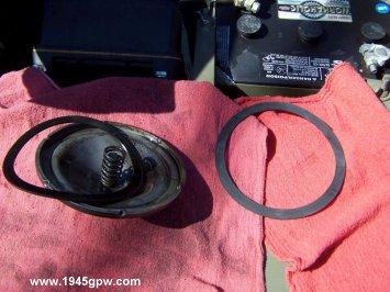 Remove the old oil filter seal from the lid, and prepare the new