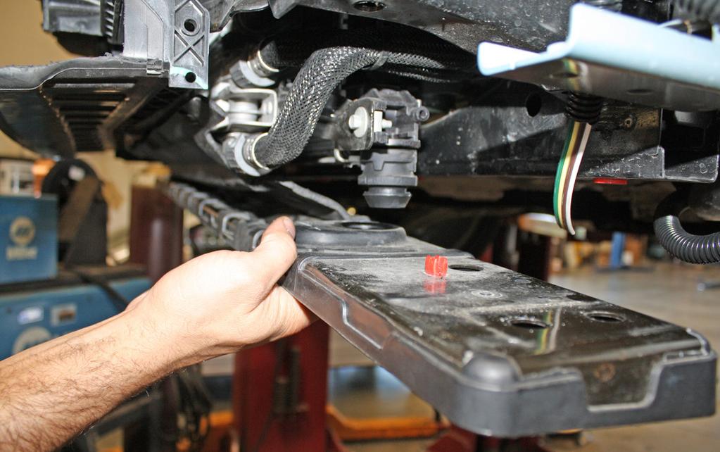 to the frame (Fig.I) and pull the radiator support out of the rubber plug.