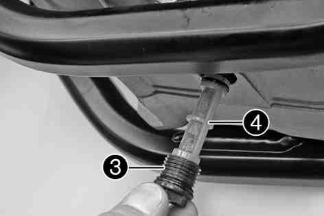 Place a suitable container under the engine. Remove oil drain plug. Completely drain the engine oil. Thoroughly clean the oil drain plug with the magnet. Clean the sealing area on the engine.