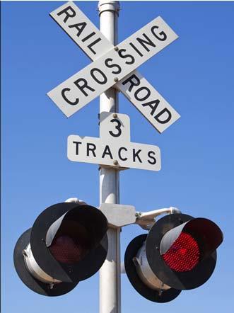 Approaching a Passive Crossing You may see a round yellow Advance Warning sign that warns drivers that railroad tracks are ahead. Pavement markings R X R, may be near the Advance Warning sign.