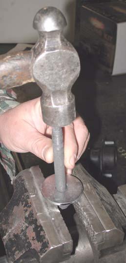 Remove the two bolts from core support mount by tapping on them with a hammer.