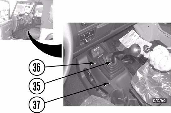 c. Squeeze and remove manual shift lever cover (36) from shift