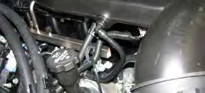 7. Remove the engine cover by lifting the front of the cover up to detach the clips, then lift the rear of