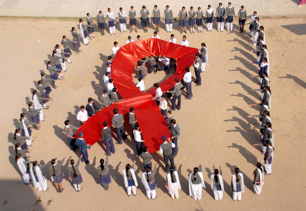 December 2013 INDIA Students of Government Model Senior Secondary School, Sector- 46, Chandigarh, India, hold up a red ribbon banner to promote AIDS awareness.