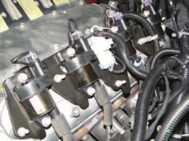 26. Unplug the coil pack main harnesses and the coil boots. Remove the driver & passenger side coil bracket assemblies by removing five (5) bolts (on each side) using a deep 10mm socket.