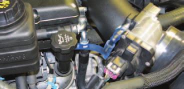 Using two (2) 1/2 hose clamps from Bag #2, install the provided brake booster vacuum hose to the brake