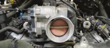 supplied plug. 83. Using a 10mm socket, remove the factory throttle body from the intake manifold.