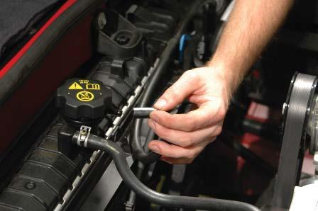 37. Release the two main upper radiator hose clamps and pull the two ends