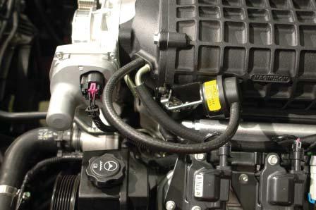 crossover and the coil bracket is a PCV hose barb covered with a cap. Remove this cap.