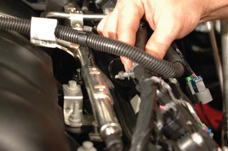 21. Pull the wire loom anchors free from the mounting holes on the OEM fuel rails on both