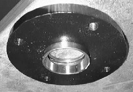 4. Remove the cotter pin and castle nut from the upper swivel plate weldment.