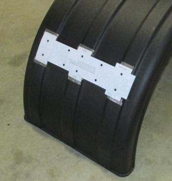Apply tape to the tabs of the template and secure the tape to the ribs of the fender as shown in Figure 12. e. Remove the fender from the wheels and confirm that all templates are secure. Figure 12 B.