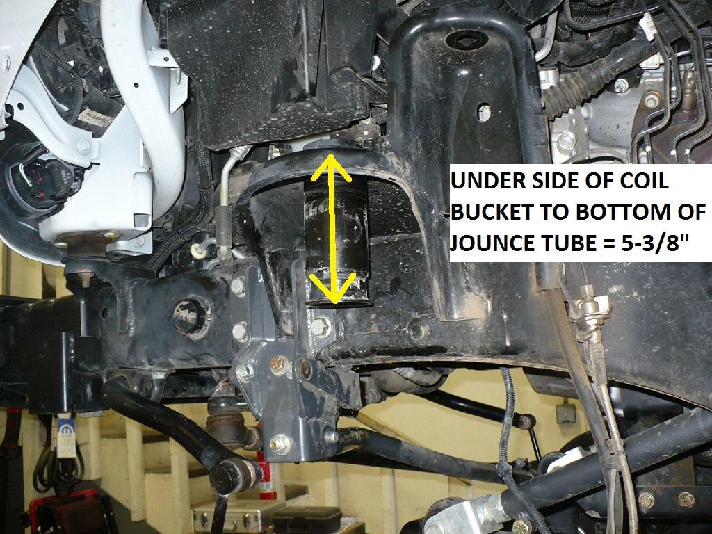 5) With upper coil spring isolators removed, remove the front bump stops and take a reference measurement from the