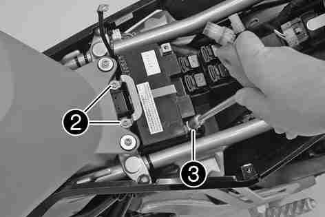 The poles of the battery must face the rear of the vehicle. Position the bracket.
