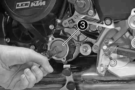 Place a suitable container under the engine. Remove screws. Remove the oil filter cover with the O-ring.