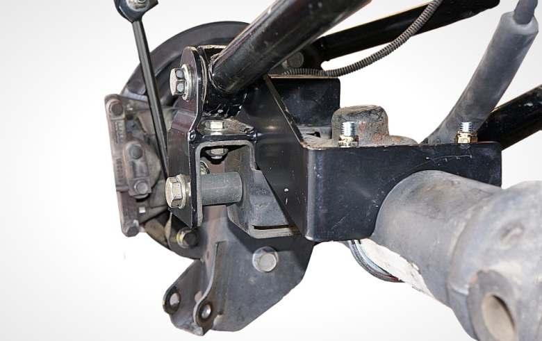 9) Attach the adjustable end of the upper control arm RS881004B to the frame bracket with the original hardware. The bend of the arm goes to the inside to provide clearance for tire.