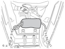 Place the connectors and excess cables in the bottom of the center console.