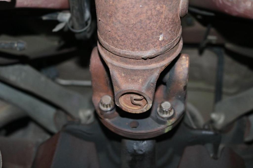 8. Once the transmission has been drained, mark and remove the driveshaft from the differential pinion flange. Note: There may be residual transmission fluid still present.