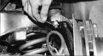 Start by reinstalling the A-arm and spring. Once again, use a safety chain. 12.