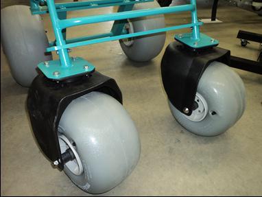 Figure 25: Rear casters with aluminum interface and collar bar. A seat was constructed out of PVC pipe and divided into three sections: a back support, bottom support, and leg support.