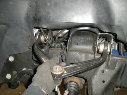 Remove the upper control arm from the frame rail.