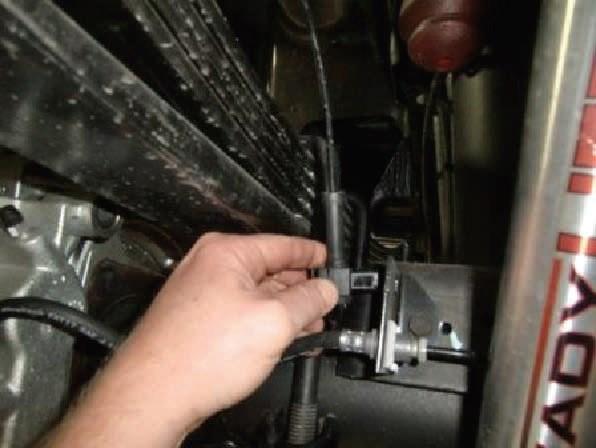 Remove the ABS harness clips from the axle to create slack.