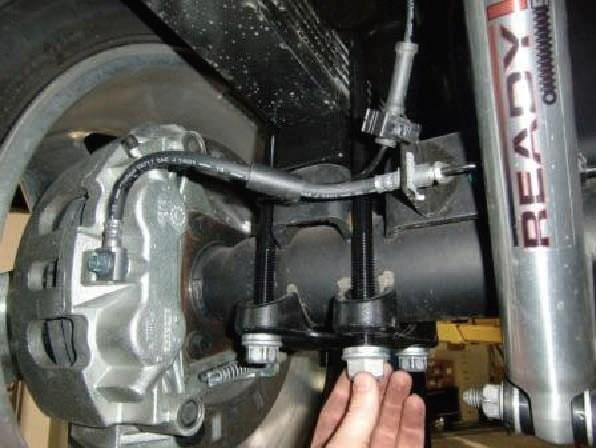 Install the provided u-bolts and hardware. Only snug the u-bolts up enough to hold the axle in place. Repeat all steps on the passenger side. Reattach the ABS harness clip to the axle.