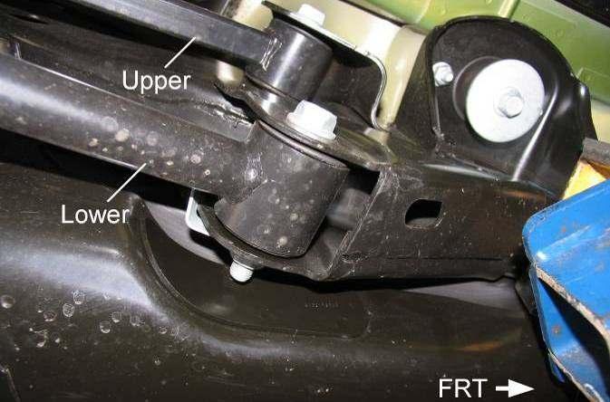 Illus. 13 3) Remove the upper suspension arm flag nut and bolt from the axle bracket. 4) Remove the flag nut and bolt at the frame rail bracket. Remove the upper suspension arm. 5) Repeat for other side.