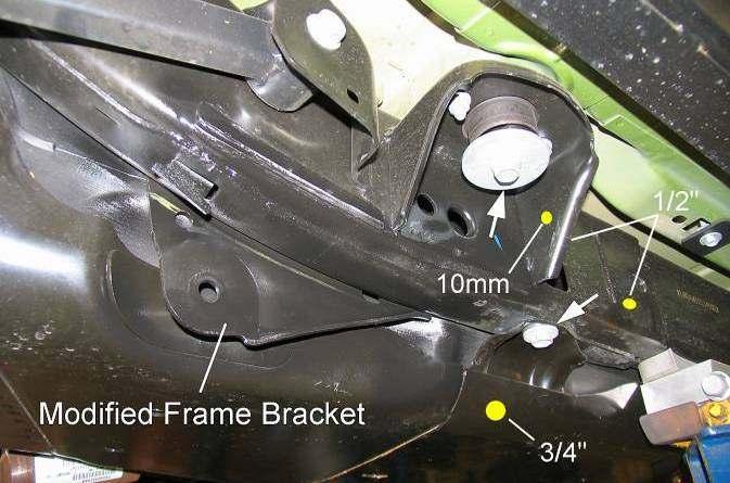 5) Using bracket RS176476B as a template, mark the mounting hole locations on the frame and body mount. Mark the relief hole location on the skid plate for the suspension arm bolt. Remove bracket.