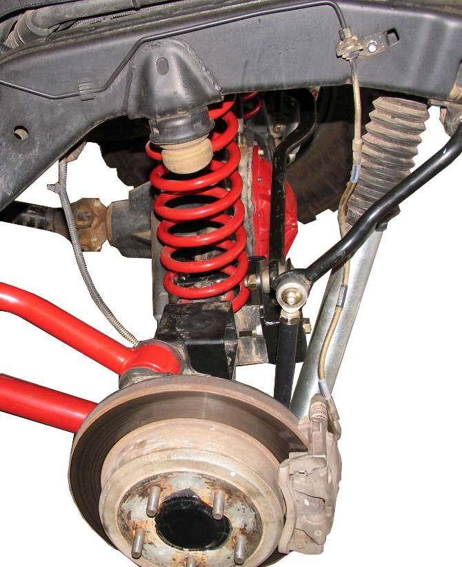 1) Separate the driver side brake hose form the brake tube and frame rail. Plug tube to prevent brake fluid leakage. 2) Remove the brake hose from the caliper. Discard copper washers.