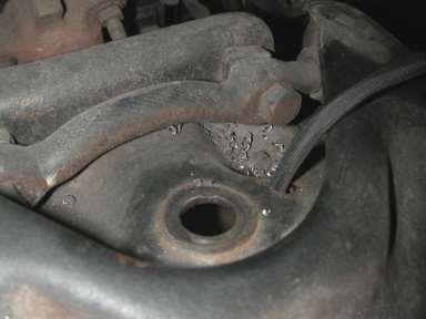 The upper coil spring retainer must be trimmed to clear the top of the Shockwave.