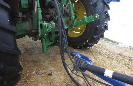 Attach the driveline to the tractor by depressing the lock pin, slide the yoke over the shaft and push on the yoke