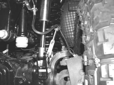 the brake line and down and behind the lower rear lower shock mount. Use the supplied zip ties and connect the vacuum line to the brake line.