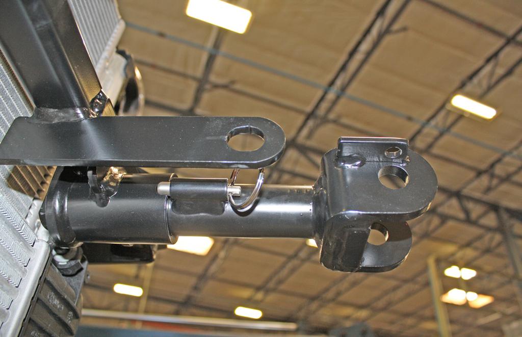 The spring-loaded pin on the removable arm snaps into a notch on the receiver, locking the removable arm into its final towing position.