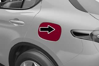 STARTING AND OPERATING Opening The Fuel Filler Door To refuel proceed as follows: 1. Open fuel filler door by pressing on the point shown by the arrow. Fuel Door 2. Remove the fuel filler cap. 3.