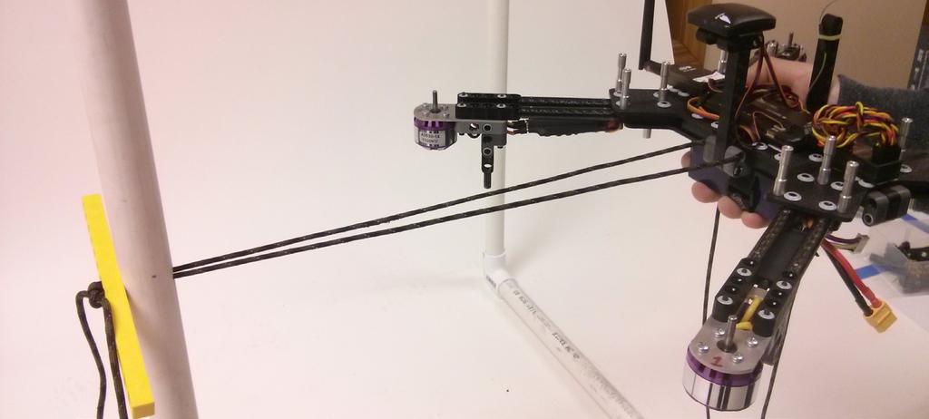 4. While one student holds the MultiRotor centered feed one side of the cord through the hole in stand an loop