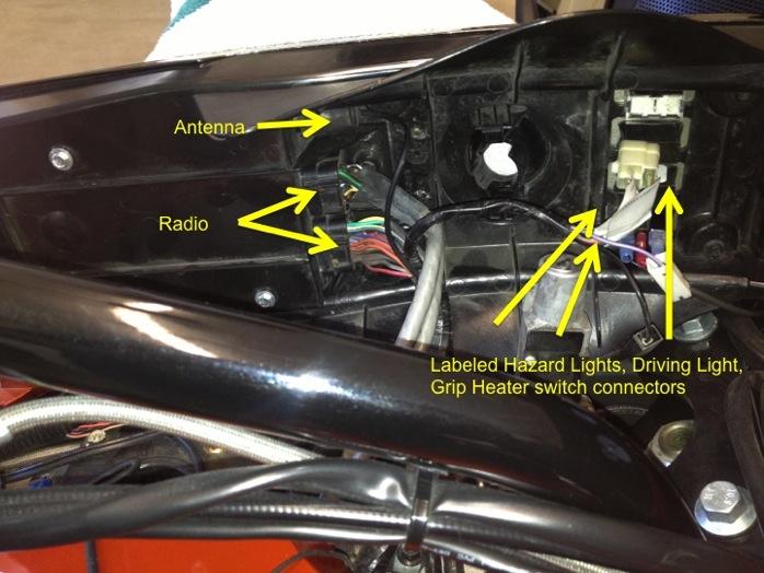 Under the center console, disconnect all the connectors. Stereo, the ANTENNA (pull towards the front of the bike to remove), the driving light, hazards, and grip heaters.