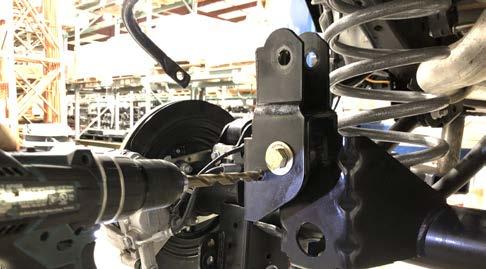 Re-install the rear track bar into the pocket of the new bracket using the new 9/16 x 3 bolt, 1/2 flat