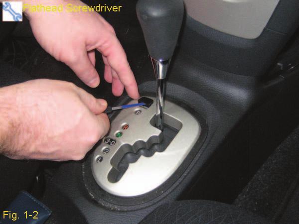 Use a flathead screwdriver to remove the shift lock cap (Fig. 1-2). NOTE: Apply protective tape to the screwdriver to prevent any scratches that may occur. 1. Disengage the shift lock and shift vehicle out of park.