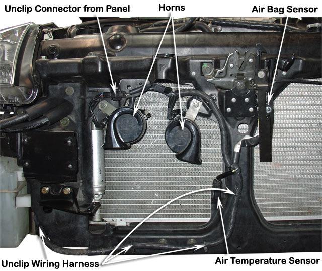 3 Remove the stock horns, air bag sensor, temperature sensor and unclip the