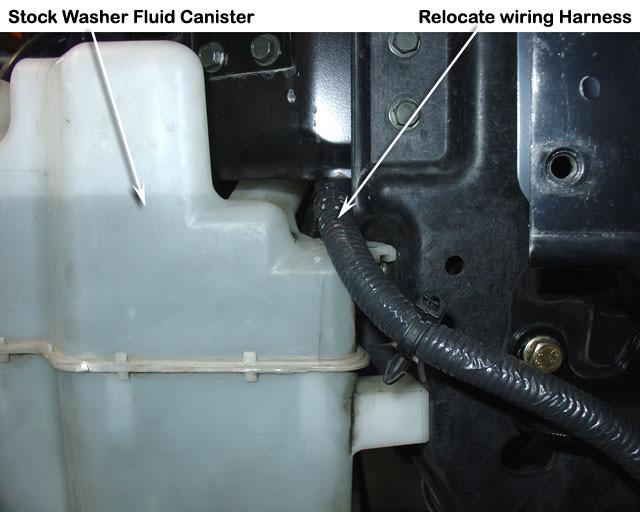 5 Remove the stock washer fluid canister and relocate the wiring loom above the washer