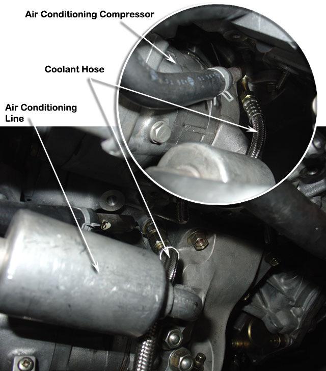 30 Route the stainless steel braided coolant hose (Item 196) under the air conditioning compressor pipes