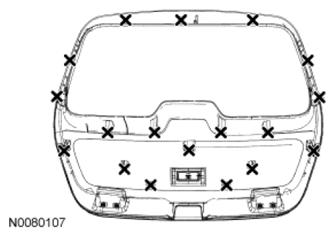 Page 15 of 33 1. NOTE: The back of the liftgate trim panel is shown in illustration indicating the location of the liftgate trim panel retainers. Remove the liftgate lower trim panel. 1. Remove the 4 liftgate lower trim panel screws.
